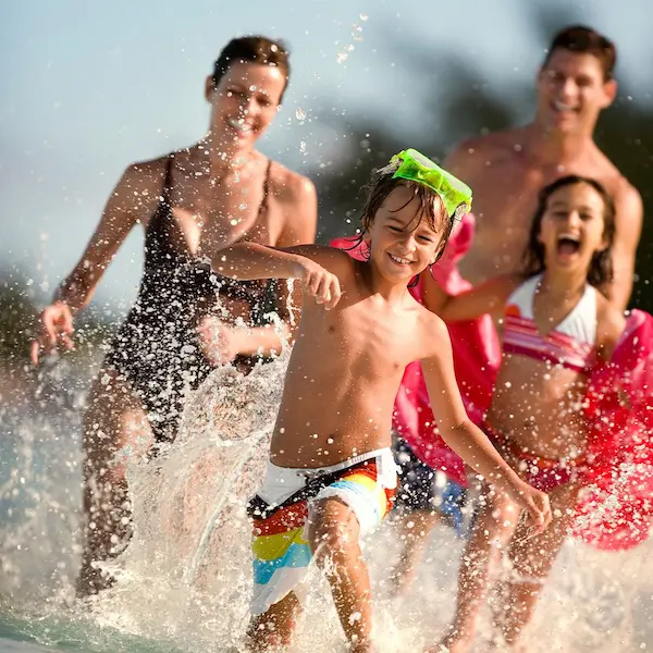 Family-running-at-the-beach The Tides