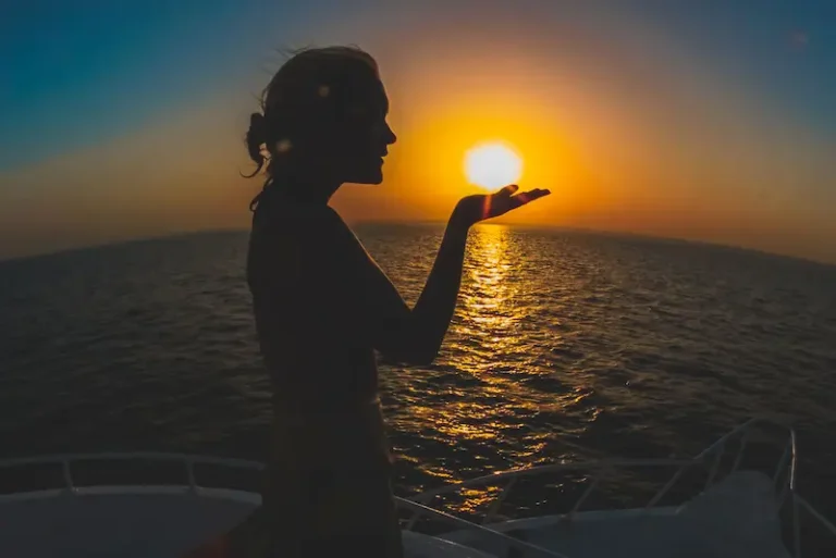 Woman-holding-sunset-in-her-palm-at-The-Tides-beachfront-768x513 The Tides