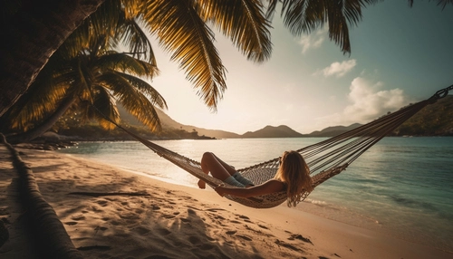 beachwalk-amenities-woman-lying-in-a-hammock-by-the-beach-at-sunset Beachwalk